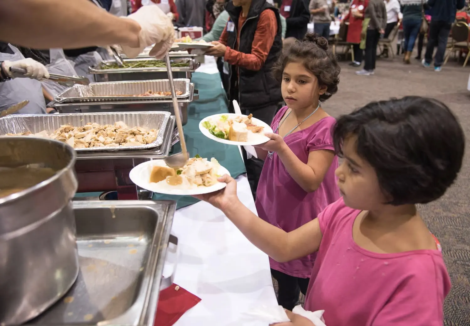 Children receiving nutritious meals at community event
