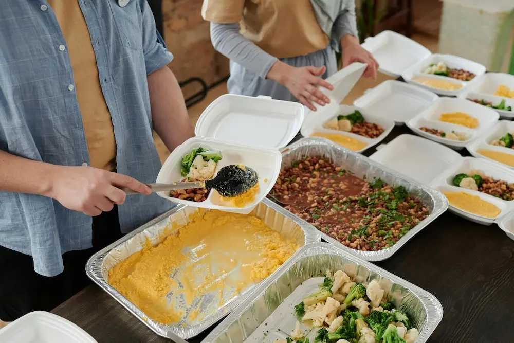 Volunteers packing nutritious meals into to-go containers